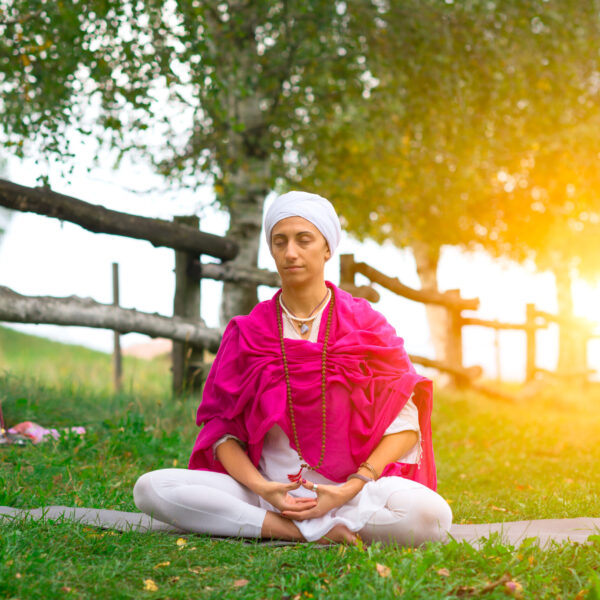 Yoga pose in nature in the sun in the meadow